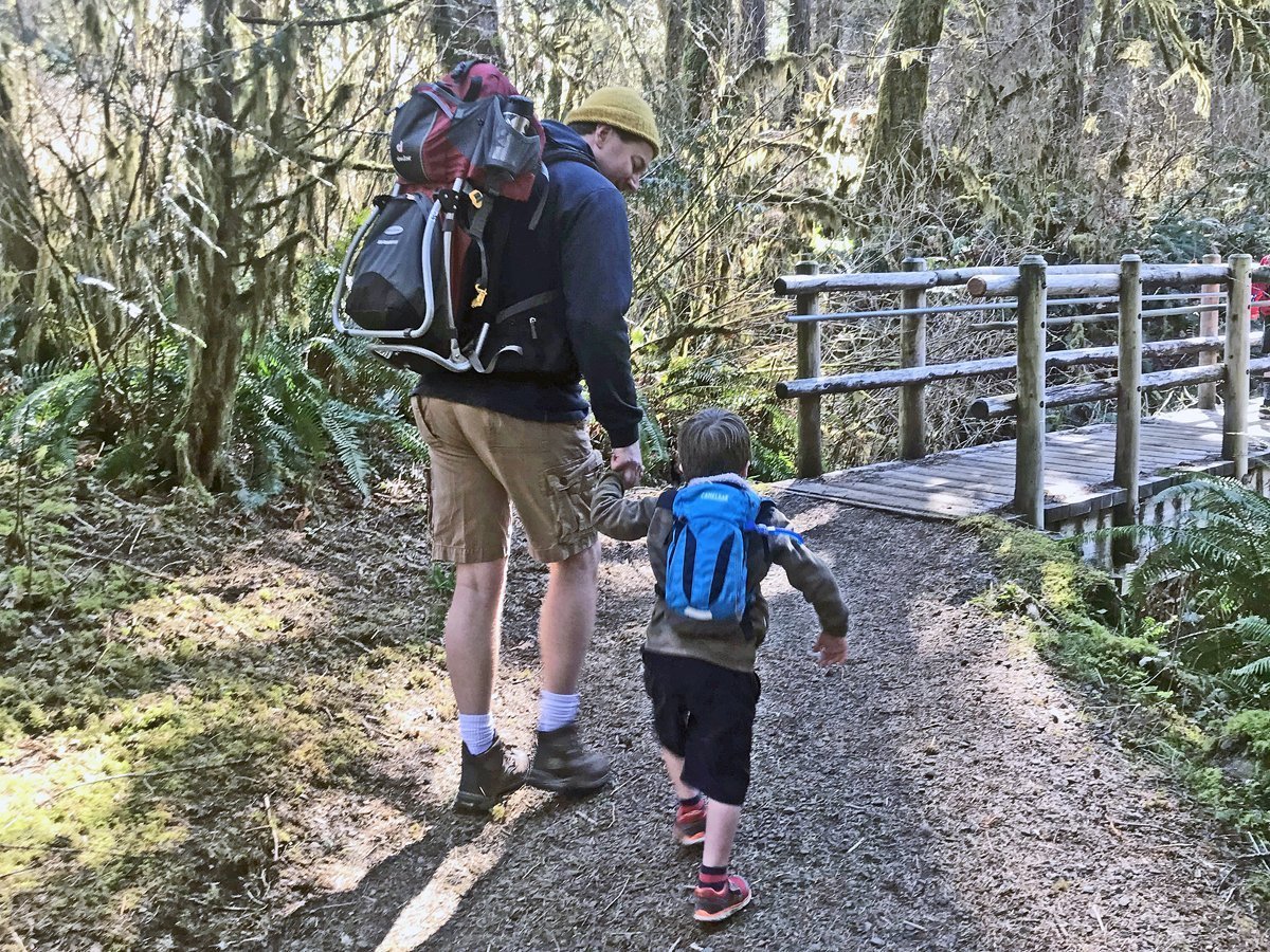 Young boy hiking with his dad - day hiking gear for kids
